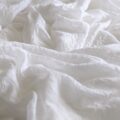 white textile on brown wooden table
